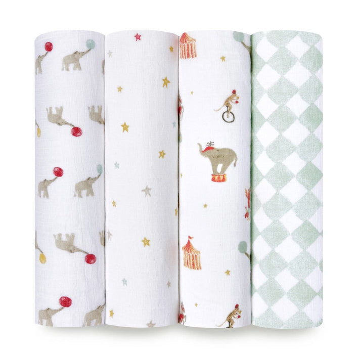 The aden + anais essentials cotton muslin swaddle blanket 4 pack features unique designs such as balloons with elephants, stars and circus tents, elephants on stools, and a green-white diamond pattern. Crafted from soft cotton muslin for ultimate comfort.