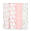 Displayed are four rolls from the aden + anais essentials cotton muslin swaddle blanket 4 pack: multicolored tulips, pink hearts, white stars on pink, and green leaves with orange dots. These soft, pastel-toned designs are crafted from breathable cotton muslin.
