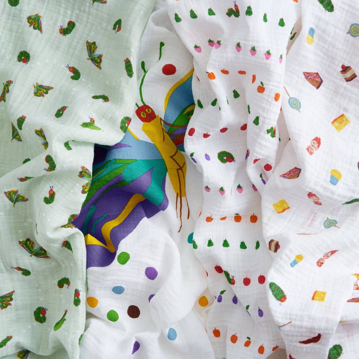 The aden + anais essentials cotton muslin swaddle blanket 4 pack features colorful The Very Hungry Caterpillar-inspired prints—caterpillars, butterfly, fruits, and polka dots in vibrant hues on white—ideal for lightweight swaddling.