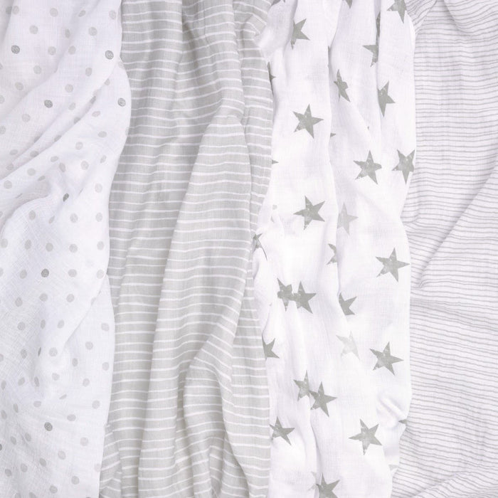 Aden + Anais Essentials Cotton Muslin Swaddles 4 Pack includes four versatile fabrics: light grey polka dots, thin grey stripes, grey stars, and white. These breathable swaddles provide style and comfort for various uses.