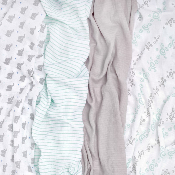 The aden + anais essentials cotton muslin swaddle blanket 4 pack features breathable fabrics with four patterns: elephants, thin green stripes, solid beige, and green spirals on white. These swaddles have a crinkled texture perfect for versatile baby blankets.