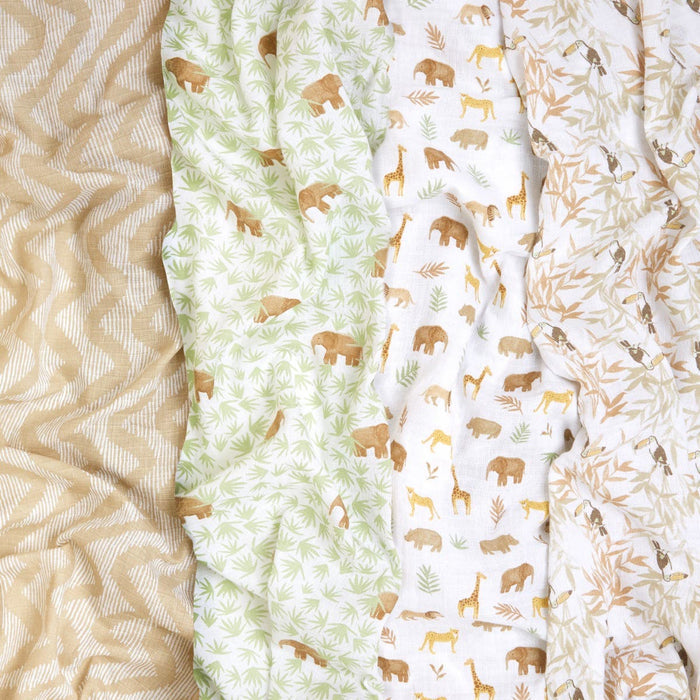 Explore the aden + anais essentials cotton muslin swaddle blanket 4 pack, featuring breathable fabrics: beige wavy lines, green with bears and leaves, white with elephants, giraffes, and lions, and white with light brown bamboo leaves—all crafted from soft cotton muslin.