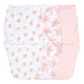 Three baby swaddles are displayed: one with a peach pattern on white, another with a pink floral design, and the third in solid pale pink. Each in aden + anaiss essentials easy swaddle wrap 3 pack has adjustable fasteners for arms-in or arms-out use.