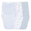 The essentials easy swaddle wrap 3 pack by aden + anais includes wraps with blue waves, whale patterns, and a light blue design. Each swaddle has adjustable fasteners to prevent the startle reflex and is neatly laid flat in a row.