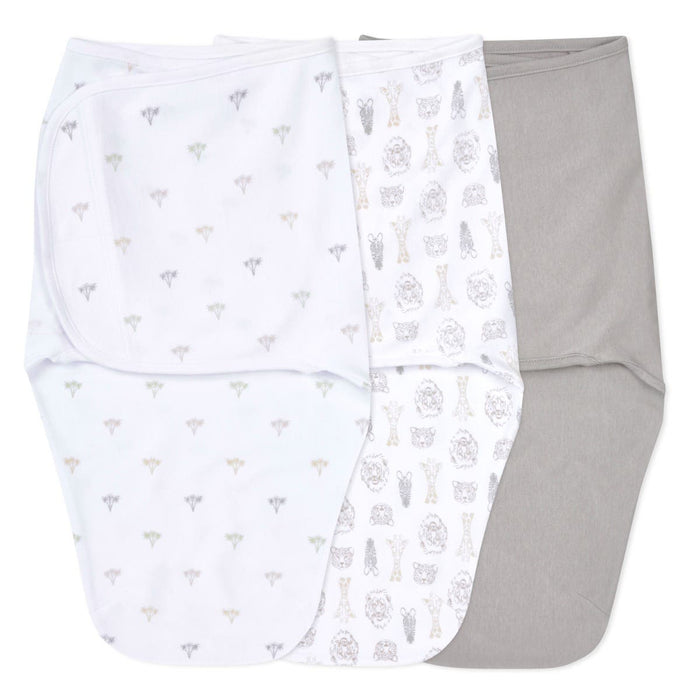 The aden + anais essentials easy swaddle wrap 3 pack features three baby swaddles: one white with small animal prints, a middle one with larger designs, and a solid gray on the right. Designed to prevent startle reflex, these wraps provide a cozy fit for your little ones comfort.