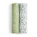 Two rolled viscose swaddles, part of the essentials silky soft swaddle blanket 2 pack by aden + anais, feature white ducks and plants on green beside a design of green leaves on white. These bamboo-infused fabrics are gentle for sensitive skin, ensuring comfort.