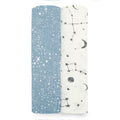 The aden + anais essentials silky soft swaddle blanket 2 pack features two rolls: one bamboo-infused blue with white speckles, and the other white with black moon, star, and constellation patterns. Perfect for a babys sensitive skin, they are displayed side by side on a white background.