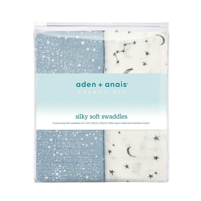 The aden + anais essentials silky soft swaddle blanket 2 pack features bamboo-infused muslin in blue with white stars and white with black star and moon designs, ideal for your babys sensitive skin. The packaging emphasizes the softness of the premium bamboo material.