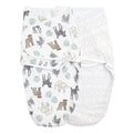 The aden + anais essentials swaddle wrap quick change 2 pack includes two baby swaddles with adjustable fasteners for secure and comfy wrapping—one adorned with safari animals and leaves, and the other featuring a beige geometric diamond pattern. Both Easy Swaddle Wraps are shown side by side against a white background.
