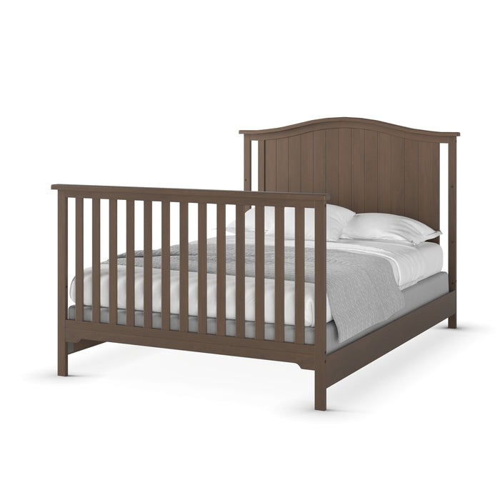 The Child Craft F06401 Full-Size Bed Rails in Dusty Heather offer sturdy pine wood support and durability, shown with a wooden frame, slatted headboard and footboard, and neatly made white pillows, sheets, and a gray blanket.
