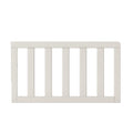 The Child Craft F09501 Toddler Guard Rail in Brushed Cotton is a white wooden bed rail with vertical slats and smooth edges, designed for compatibility with Child Craft cribs and shown against a plain white background.