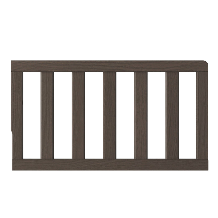 The Child Craft F09501 Toddler Guard Rail in Dapper Gray features sturdy wood construction and vertical slats, shown from the side against a white background.