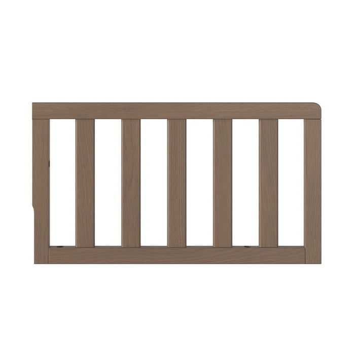 The Child Craft F09501 Toddler Guard Rail in Dusty Heather features vertical slats and easily attaches to Child Craft cribs or beds to provide added security during crib conversion.