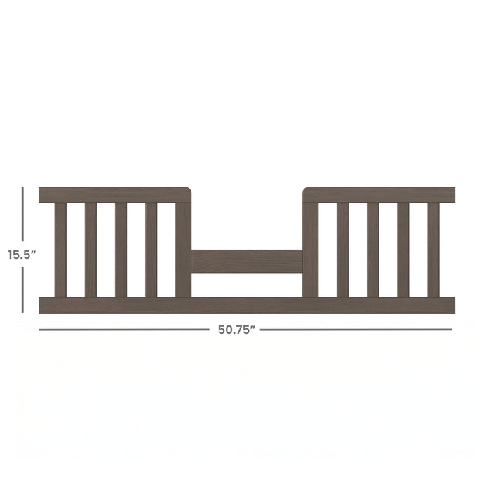 The Child Craft F09514 Toddler Guard Rail in Dapper Grey features vertical slats on both sides, a lower center rail, and measures 15.5" tall x 50.75" wide—perfect for converting a toddler bed or crib.