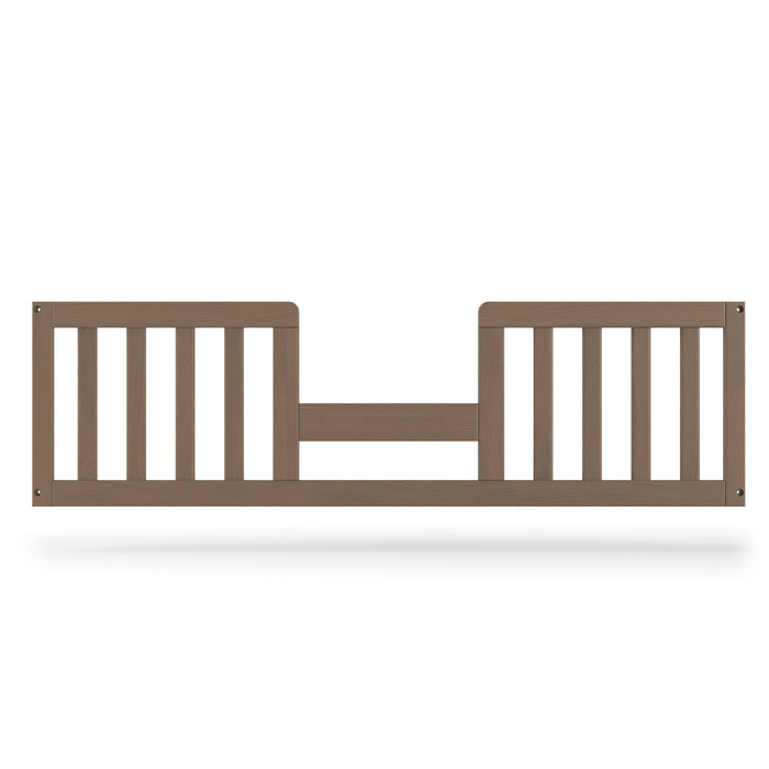 The Child Craft F09514 Toddler Guard Rail in Dusty Heather features sturdy wood construction with vertical slats and a low, open center, securely attaching to prevent falls during toddler bed conversion.
