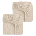 Two HALO Fitted Crib Sheets, 100% Organic Cotton Muslin, in beige, folded and stacked with gathered elastic edges shown against a white background. Set of 2 pack.