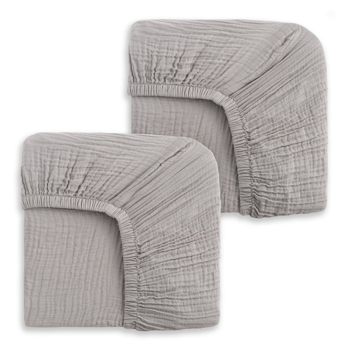 Two folded HALO Fitted Crib Sheets, 100% organic cotton muslin, in light gray with elastic edges are stacked side by side on a white background. Comes as a 2 pack.