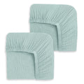 The HALO Fitted Crib Sheets 100% Organic Cotton Muslin 2 Pack features two neatly folded light teal sheets with elastic edges and soft, breathable fabric—offering comfort and style for your nursery.