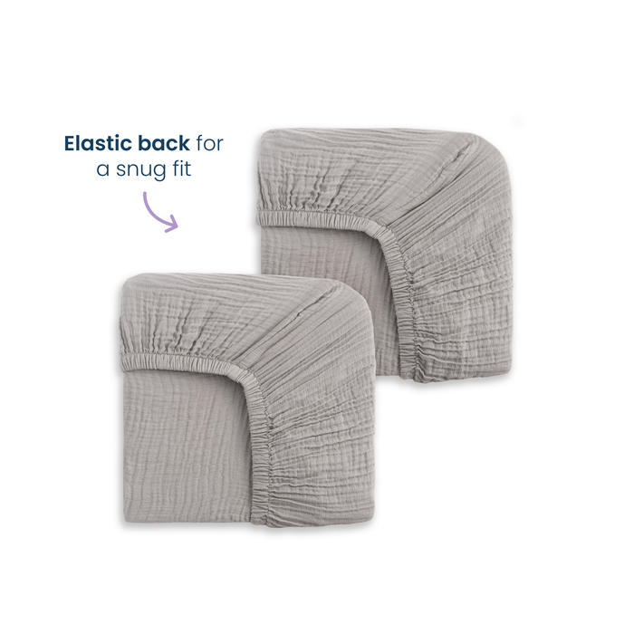 Two gray HALO Fitted Crib Sheets 100% Organic Cotton Muslin are shown side by side. A label highlights the elastic back for a snug fit. These soft, organic sheets come in a 2 pack, perfect for comfort and style in your nursery.