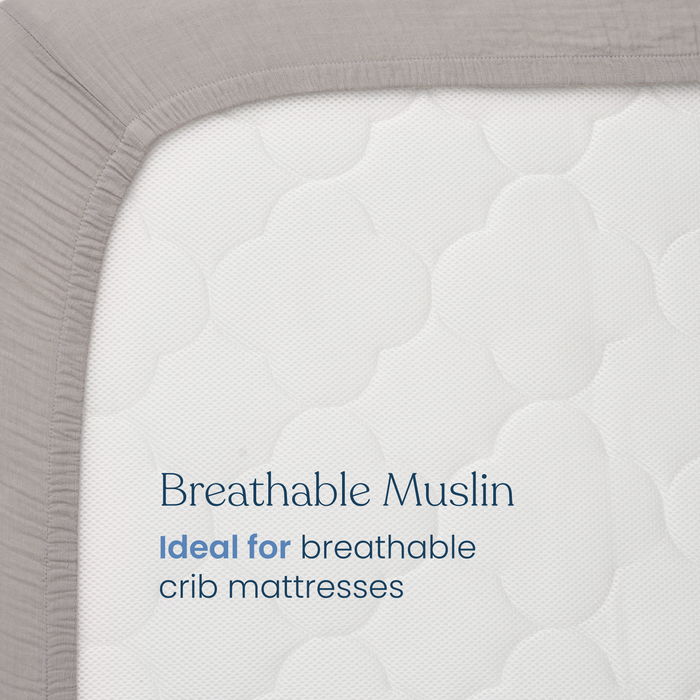 Close-up of HALO Fitted Crib Sheets 100% Organic Cotton Muslin 2 Pack, featuring a gray, breathable muslin cover with a quilted cloud-like pattern. Ideal for breathable and fitted crib sheets. Text reads: Breathable Muslin.