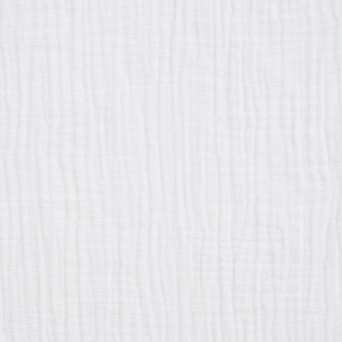A close-up of HALO Fitted Crib Sheets 100% Organic Cotton Muslin 2 Pack shows white, textured fabric with a subtle vertical crinkle—these breathable sheets look soft, lightweight, and ideal for a cozy nursery.