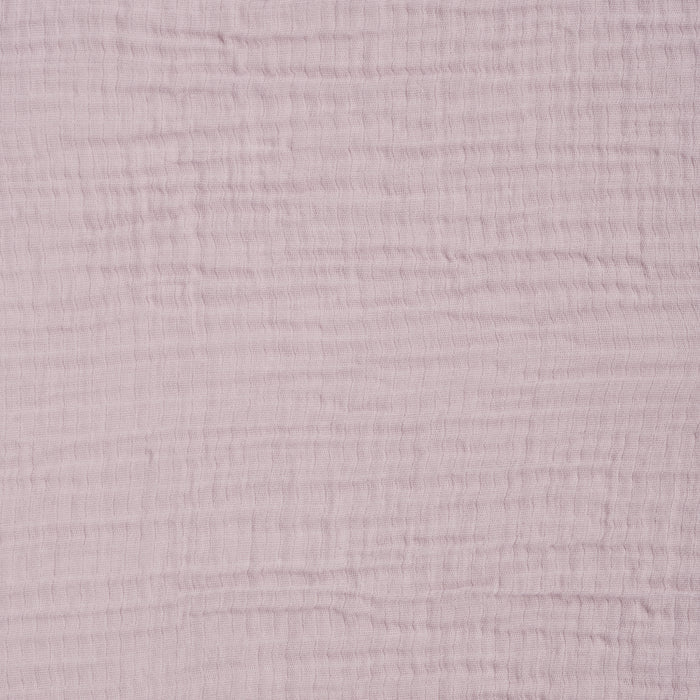 Close-up of HALO Fitted Crib Sheets 100% Organic Cotton Muslin 2 Pack in light pink, showing breathable, soft gauzy fabric with a subtle grid pattern formed by horizontal and vertical lines.