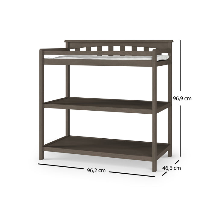 The Child Craft Flat Top Baby Changing Table in Dapper Gray features two open shelves for nursery storage and measures 96.2 cm wide, 46.6 cm deep, and 96.9 cm high. A thin baby changing pad on top adds comfort for your little one.