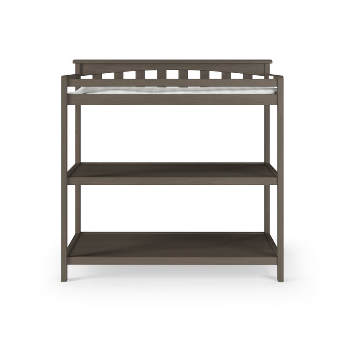 The Child Craft Flat Top Baby Changing Table in Dapper Gray features a top baby changing pad and two open storage shelves, shown against a white background.