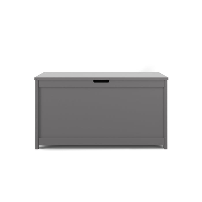 The Child Craft Harmony 33" Kids Toy Box in Cool Gray features a rectangular design with a flat top, front-facing panel, and a cut-out handle near the top center for easy lid opening.