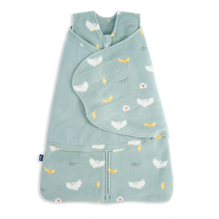The HALO Harry Potter™ Swaddle Micro-Fleece TOG 3.0 is a soft, light teal sleep sack with wraparound closure, featuring white owls, yellow lightning bolts, eyeglasses, and envelopes—magical comfort with a bottom zipper for easy changes.