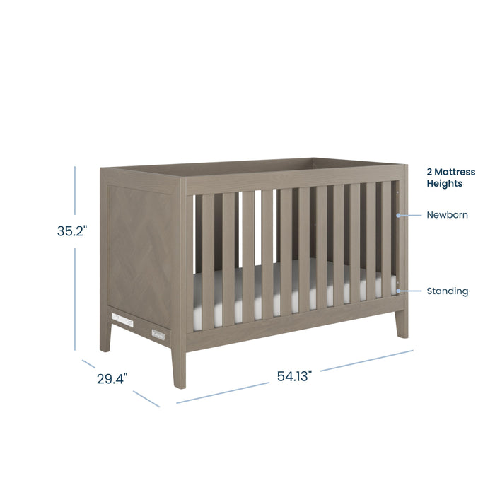 The Child Craft Kieran 3-in-1 Convertible Crib in Crescent Gray features slatted sides and two mattress heights. Measuring 35.2" H x 29.4" D x 54.13" W, it easily converts to a toddler bed as your child grows.