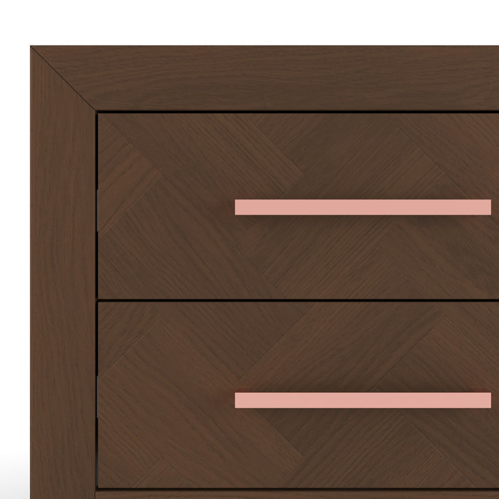 Close-up of the Child Craft Kieran Nightstand in Toasted Chestnut, a wooden nightstand with a herringbone pattern and two drawers, each featuring a long light pink handle. Ideal bedside storage for a baby’s nursery against a white background.