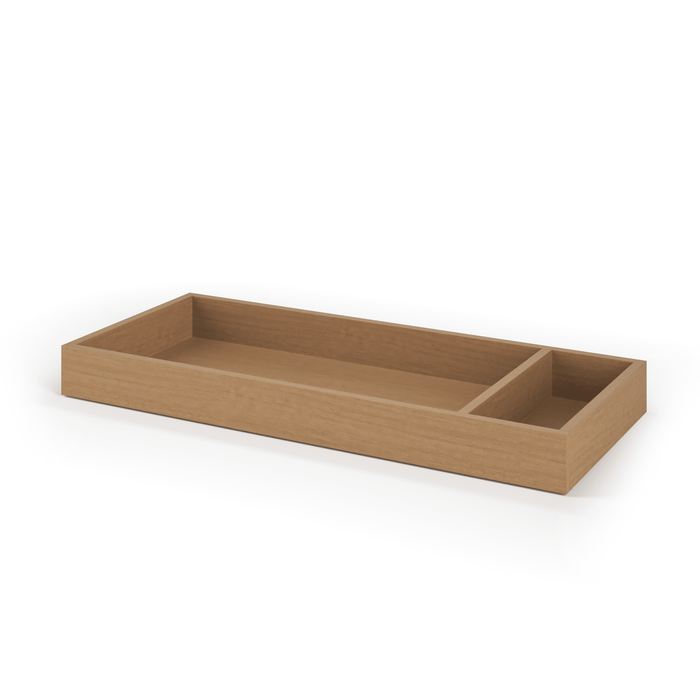 The Child Craft Legacy Changing Table Topper in Biscotti is a rectangular wooden tray with a natural finish, featuring two compartments—one large and one smaller on the right—ideal for organizing essentials on your dresser changing kit.