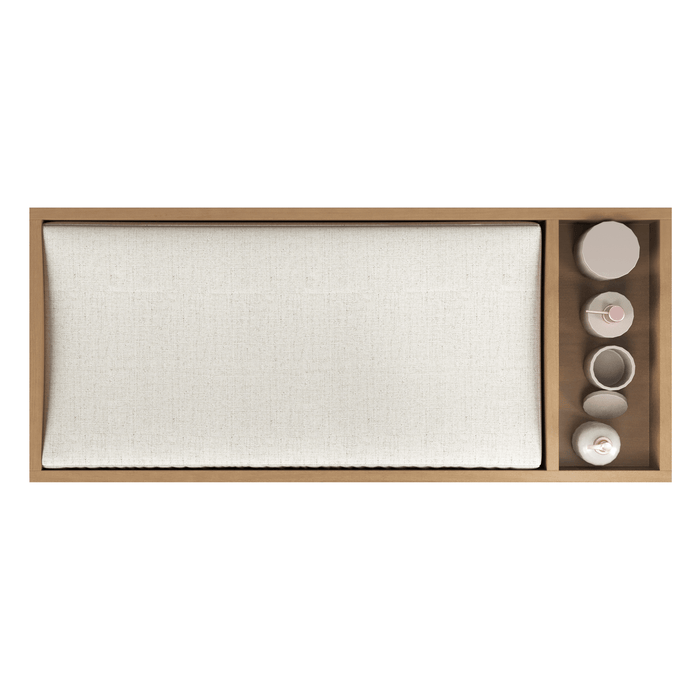 Top view of the Child Craft Legacy Changing Table Topper in Biscotti, featuring a large rectangular cream cushion and a side section with four neutral-toned ceramic cups and bowls.
