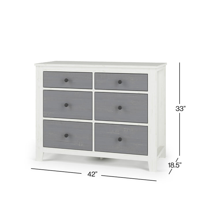 The Child Craft Ocean Grove Double Dresser in White/Gray is a nursery piece with a nautical farmhouse vibe, featuring six gray drawers with round black knobs. It measures 33"H x 42"W x 18.5"D.