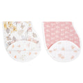 The aden + anais organic cotton muslin burpy bibs 2 pack showcases two GOTS-certified bibs. One features a floral and butterfly pattern on white, while the other has a white floral design on pink. Both offer rounded bottoms with an extra fabric fold for added convenience.