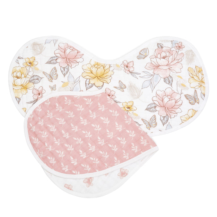 The aden + anais organic cotton muslin burpy bibs 2 pack features a burp cloth with pastel yellow and pink floral patterns on one side and a soft pink side with a white leaf design, offering both style and comfort for your little one.