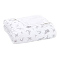 The folded aden + anais organic cotton dream blanket in white features subtle gray moons and whales, offering a gentle touch ideal for a baby blanket.