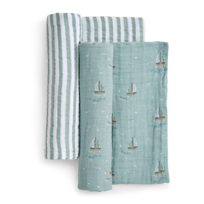 The aden + anais organic cotton muslin swaddle blanket 2 pack includes two soft, sustainable blankets: one green and white striped, the other light green with sailboat patterns. GOTS certified and crafted from breathable fabric, they keep your little one cozy.
