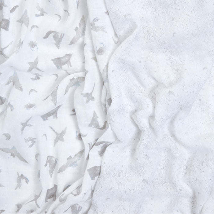 The aden + anais organic cotton muslin swaddle blanket 2 pack features GOTS-certified white fabric with a subtle pattern of sharks and ocean shapes, highlighted by light grey and soft blue accents. Its slightly crumpled texture gives a delicate, airy look, perfect for adding depth to baby essentials.