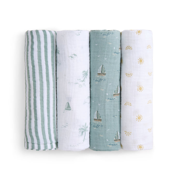 The aden + anais organic cotton muslin swaddle blanket 4 pack features designs arranged vertically: green and white stripes, sailboats on white, teal with sailboats, and yellow suns on white.