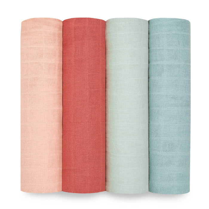 The aden + anais organic cotton muslin swaddle blanket 4 pack features GOTS certified fabric in light peach, warm coral, pale mint, and light teal. These subtly textured fabrics are perfect for crafting sustainable swaddles or organic muslin swaddle blankets.