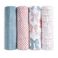 The aden + anais organic cotton muslin swaddle blanket 4 pack features four rolled blankets, each with unique patterns: blue with white bows, red and white checks, large blue and pink bows, and pink bows on white.
