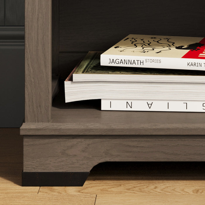 A close-up of the Child Craft Redmond Nightstand in Dapper Gray shows two stacked books: the top one titled "Jagannath Stories" and the bottom one, white with bold black text, partially visible on its spine.