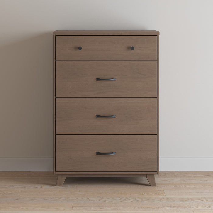 The Child Craft Soho 4 Drawer Chest in Dusty Heather features three curved black handles, a top drawer with two round knobs, and short angled legs—making it a stylish, functional choice for a modern nursery.