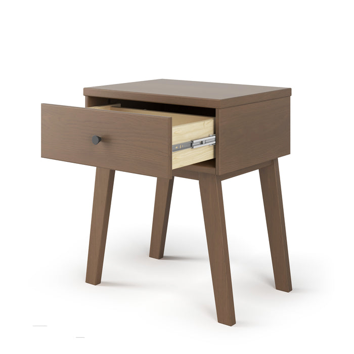 The Child Craft Soho Nightstand in Dusty Heather features four angled legs and a single drawer partially open to reveal a light interior and metal slide, all showcased against a plain white background.