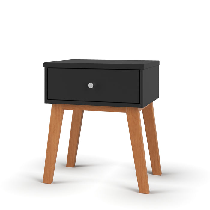The Child Craft Soho Nightstand in Ebony features a black rectangular drawer with a round silver knob and four angled wooden legs. Its minimalist, mid-century style makes it a chic choice for a nursery or kid’s nightstand.