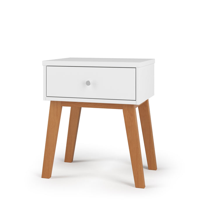 The Child Craft Soho Nightstand in White/Natural features a single white drawer with a round knob and four slanted natural wood legs, shown against a plain white background. Perfect as nursery furniture or for use as a kid's nightstand.