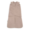 A beige HALO Swaddle SuperSoft Bamboo TOG 2.0, featuring a front zipper, bamboo fabric, and a 3-way adjustable design with velcro straps for wrapping, is laid flat on a white background.