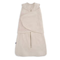 The HALO SuperSoft Bamboo Swaddle TOG 2.0 in beige is a sleeveless swaddle made from soft bamboo, featuring a front zipper and adjustable Velcro wings for secure swaddling.